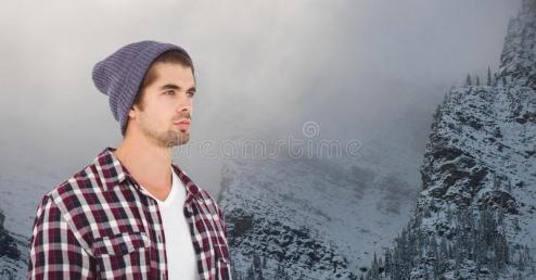young-hipster-wearing-knit-hat-against-snowcapped-mountains-digital-composite-92885255